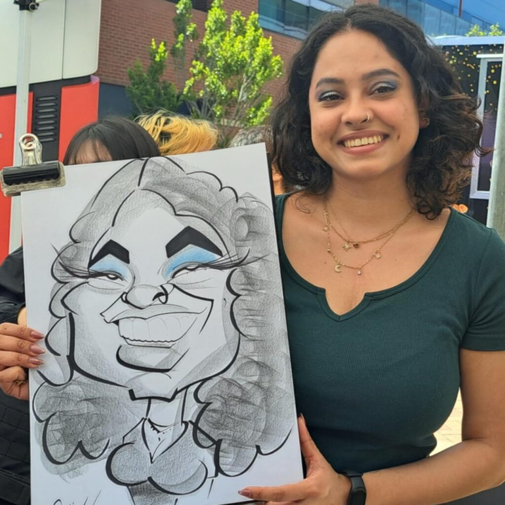 caricature artist with couple at party